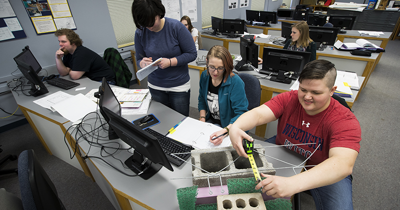Students work with materials in architectural commercial design Students work with materials and on the computer in architectural commercial design