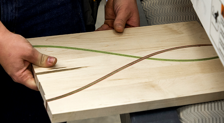 A student using a CNC machine for a woodworking project