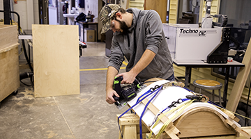 A student working on furniture production