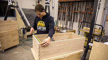 A student working on furniture production