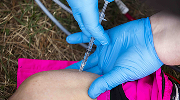 Advanced EMT student practicing an intravenous injection